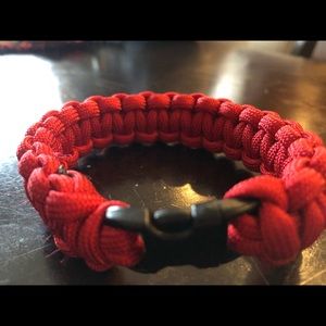 Solid Red paracord rope bracelet with a black clip